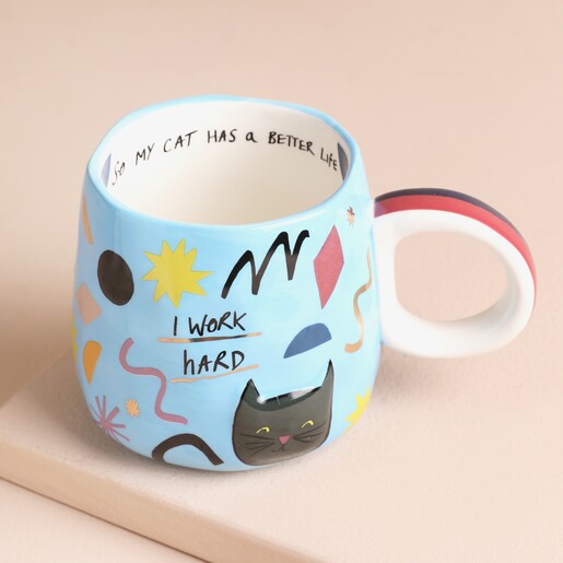 House of Disaster Small Talk 'I Work Hard' Cat Mug on a Beige Background