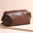 Men's Vegan Leather Wash Bag in Brown on Beige Platform