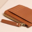 Close up of zip on Personalised Vegan Leather Card Holder in tan against neutral background