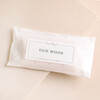 Oud Wood Soy Wax Melts in packaging on a beige background