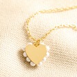 Estella Bartlett Pearl Heart Necklace in Gold on Beige fabric