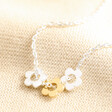 Estella Bartlett Mixed Metal Flower Charm Necklace in Silver on Beige Fabric