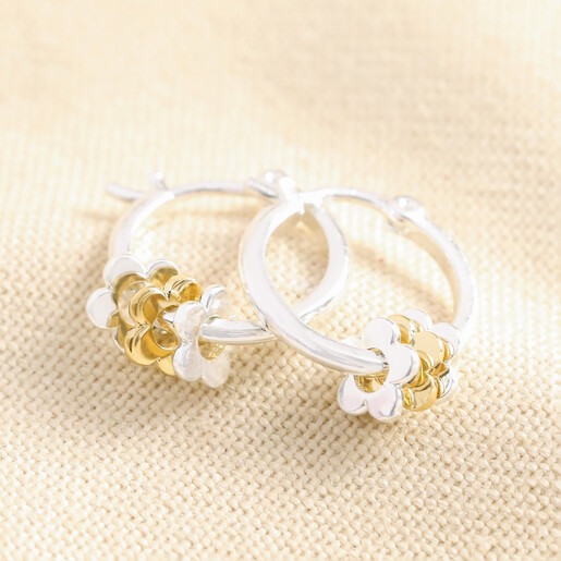 Estella Bartlett Mixed Metal Floral Hoop Earrings in Silver on Beige Fabric