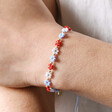 Close Up of Estella Bartlett Red and Blue Daisy Chain Bracelet on Model