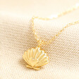 Estella Bartlett Scallop and Heart Pendant Necklace in Gold on Beige Fabric