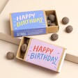 Seedball Assorted Happy Birthday Seed Ball Matchbox Gifts in blue and pink on top of neutral backdrop