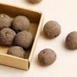 Close up of balls inside of Seedball Assorted Thank You Seed Ball Matchbox Gift