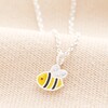 Sterling Silver Tiny Bee Pendant Necklace on Beige Background