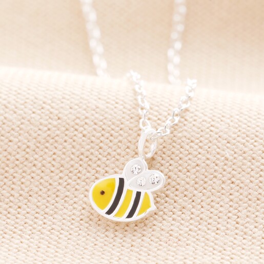 Sterling Silver Tiny Bee Pendant Necklace on Beige Background Sterling Silver Tiny Bee Pendant Necklace on Beige Background