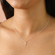 Close up of Sterling Silver Small Cross Pendant Necklace on a Model