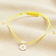 Sterling Silver Yellow Daisy Cord Bracelet on Beige Fabric