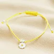 Sterling Silver Yellow Daisy Cord Bracelet on Beige Fabric