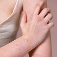 Model Wearing Sterling Silver Yellow Daisy Cord Bracelet with Hand on Arm