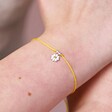 Close Up of Sterling Silver Yellow Daisy Cord Bracelet on Model