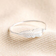 Sterling Silver Feather Ring on Beige Fabric