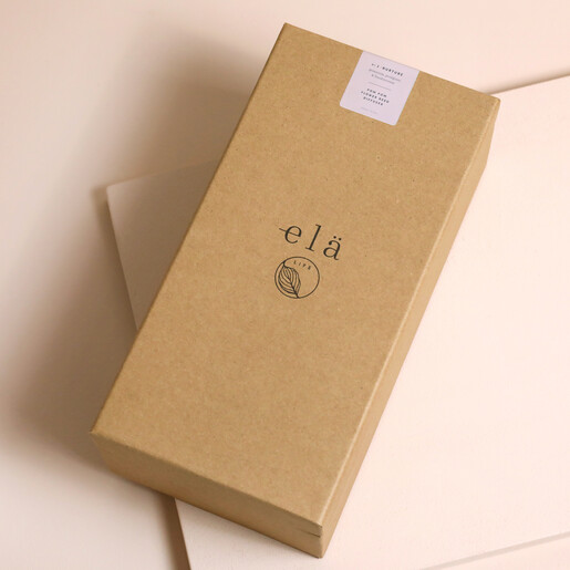 Elä Life Nurture No. 2 Pom Pom Flower Diffuser inside of gift box against beige backdrop