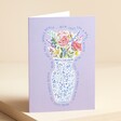 Mum Bouquet Purple Mother's Day Card standing in front of beige backdrop