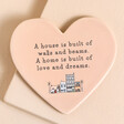 Home is Built of Love and Dreams Ceramic Heart Coaster in pink against beige backdrop