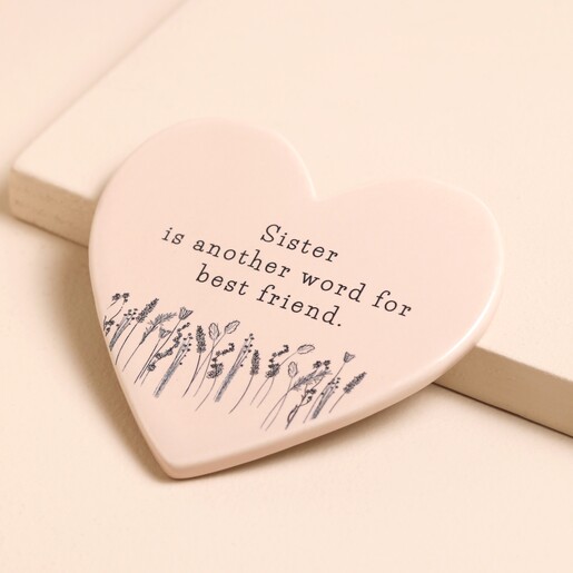 Sister Ceramic Heart Coaster against raised beige surface