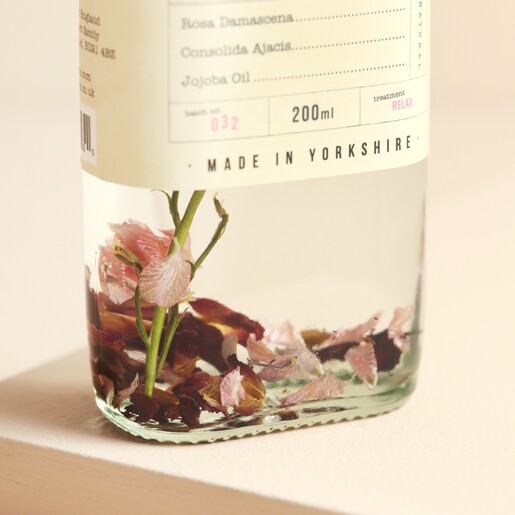 Bottom of Fikkerts Fruit of Nature Rose Bath Essence bottle showing dried flowers