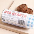 Packaging of The Chocolate Gift Co Dad Hearts with two chocolate discs beside them
