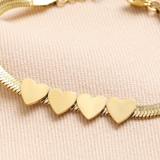 Close Up of Charms Close Up of 4 Heart Charms on Gold Stainless Steel Four Heart Charm Herringbone Bracelet