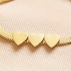 Close Up of 3 Flat Heart Charms on Gold Stainless Steel Three Heart Charm Herringbone Bracelet