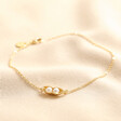 Pearl Two Peas in a Pod Charm Bracelet in Gold on Beige Fabric
