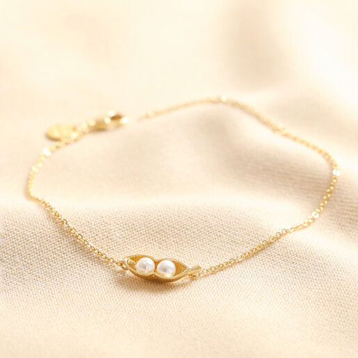 Pearl Two Peas in a Pod Charm Bracelet in Gold on Beige Fabric