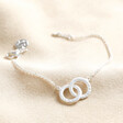 Personalised Interlocking Matte Circles Bracelet in silver on top of beige coloured backdrop