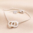 Personalised Interlocking Pearl and Crystal Hoops Bracelet in silver on beige coloured fabric