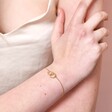 Model wearing Personalised Interlocking Pearl and Crystal Hoops Bracelet in gold with hand on arm