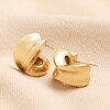 Chunky Organic Hoop Earrings in Gold on top of beige coloured fabric