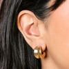 Close up of Chunky Organic Hoop Earrings in Gold on model