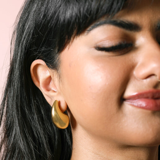 Gold Stainless Steel Oversized Teardrop Stud Earrings on model smiling