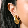 Close up of Gold Stainless Steel Oversized Teardrop Stud Earrings on model