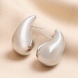 Chunky Teardrop Drop Stud Earrings in Silver on Beige Fabric