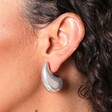 Close Up on Chunky Teardrop Drop Stud Earrings in Silver on Model