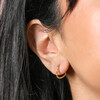 Close Up of Model Wearing Small Heart Huggie Hoop Earrings in Gold