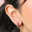Close up of Stainless Steel Huggie Hoop Earrings on model