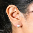 White Enamel Mushroom Stud Earrings in Gold on model ear