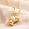 Croissant Pendant Necklace in Gold on Beige Fabric