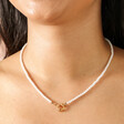 Close Up of Gold Stainless Steel Pearl Toggle Necklace on Model