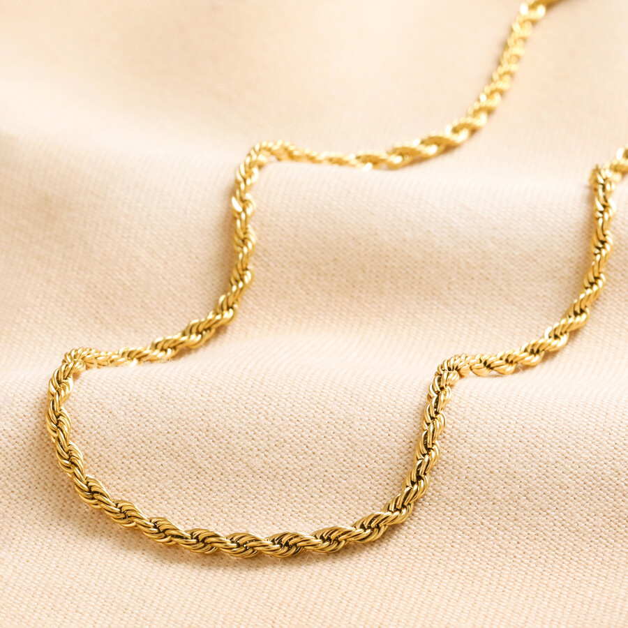 Gold Stainless Steel Rope Chain Necklace laid on top of beige coloured material