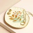 Leaf Organic Trinket Dish with jewellery inside against beige coloured backdrop