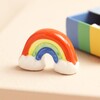 Tiny Matchbox Ceramic Rainbow Token outside of packaging 