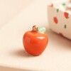 apple from Tiny Matchbox Ceramic Apple Teacher Token outside of matchbox
