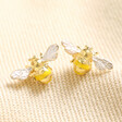 Yellow Enamel Bee Stud Earrings in Gold on Beige Fabric