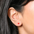 Close Up of Gold Sterling Silver Red Enamel Heart Stud Earrings On Model 