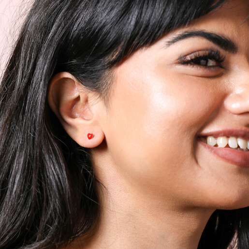 Gold Sterling Silver Red Enamel Heart Stud Earrings on smiling Model